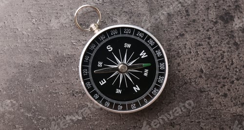 Preview: One compass on grey table, top view