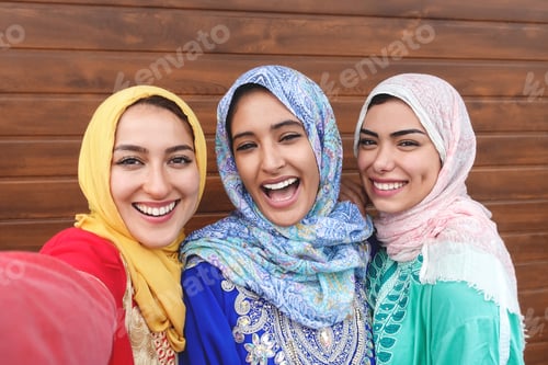 Preview: Happy Muslim girls taking selfie outdoor