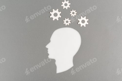 Preview: top view of cut out white human head with gears isolated on grey