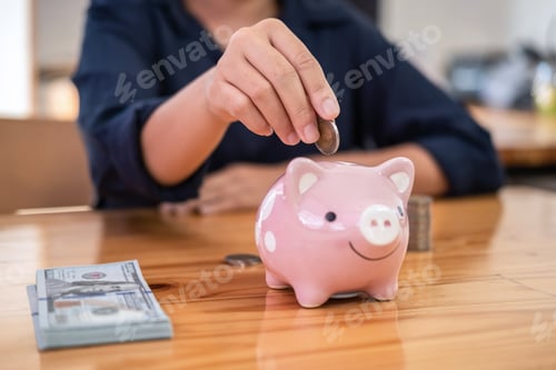 Preview: Woman putting coins into piggy bank planning growing saving to strategy with money box for future