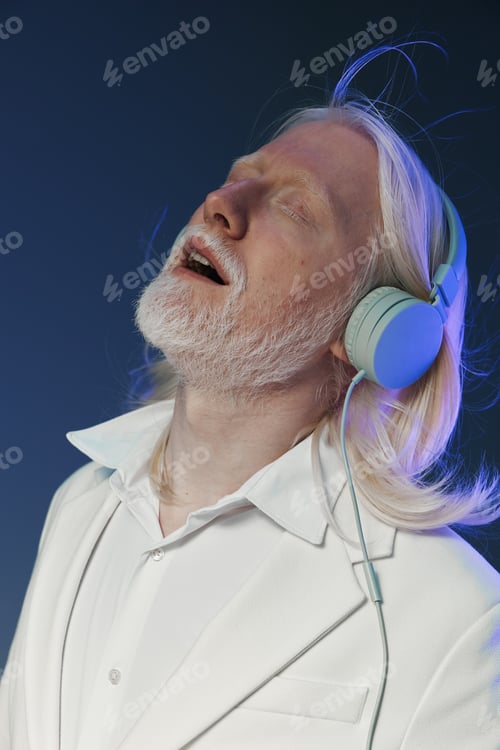 Preview: man enjoying music, wearing headphones, white suit, blue background, relaxed expression, long white