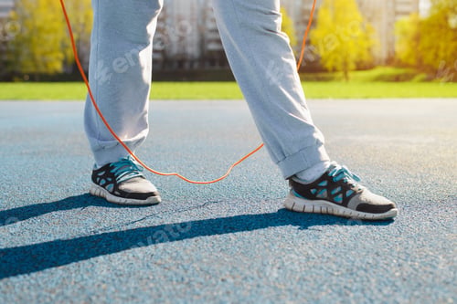 Preview: Fitness, aerobics and active lifestyle concept. Close-up of woman jumping on skipping rope,