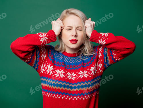 Preview: Beautiful woman in Christmas sweater on green background