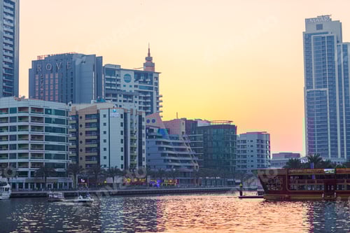 Preview: Dubai Marina canal with boats in Dubai during sunset