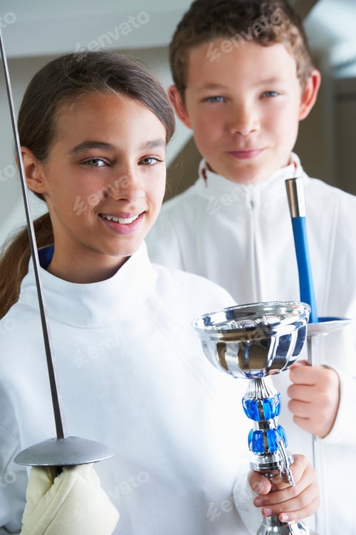 Preview: Smiling girl holding fencing trophy