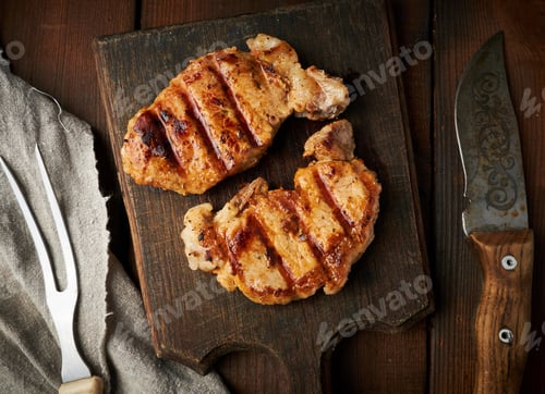 Preview: Pork fried steak lies on a vintage brown wooden board