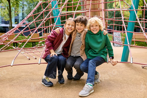Preview: Friends enjoying autumn adventures at the playground, creating joyful childhood memories together