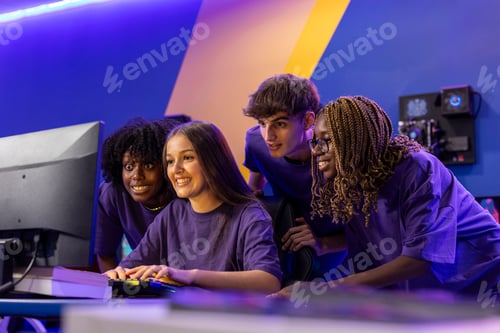Preview: Gamers playing on computer in gaming room