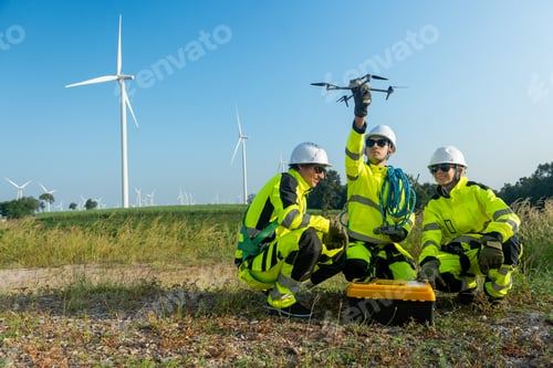 Preview: Wide shot of group of wind turbine or windmill workers or technician check for preparing use drone