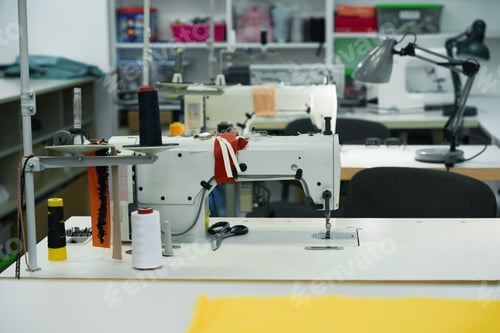 Preview: Modern sewing machines on the tables in the workshop