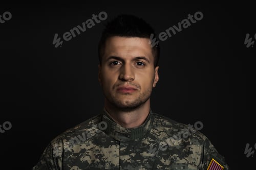 Preview: young serviceman in uniform suffering from ptsd and looking at camera isolated on black