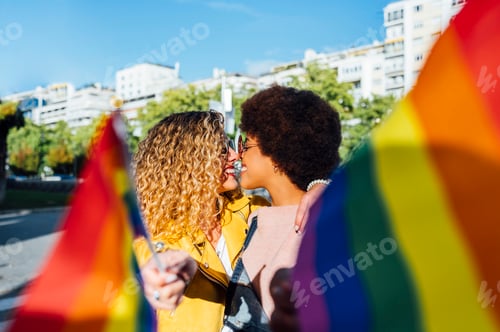 Preview: Two women friends hanging out in the city waving LGBT