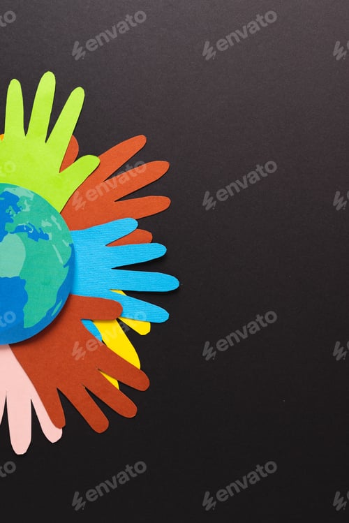 Preview: Paper cut out of multi coloured hands and globe with copy space on black background