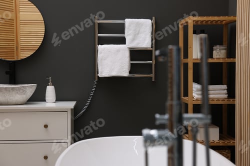 Preview: Stylish bathroom interior with heated towel rail and modern furniture