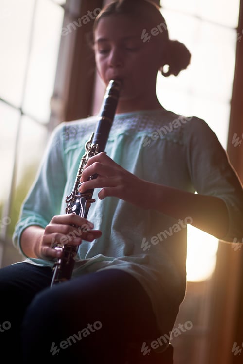 Preview: Young musician immersed in playing the clarinet