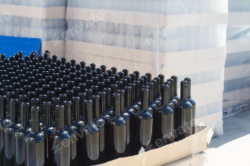 Preview: black wine bottles on pallets in outside storage area