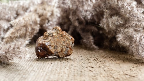 Preview: Raw andradite rock mineral sample on wood