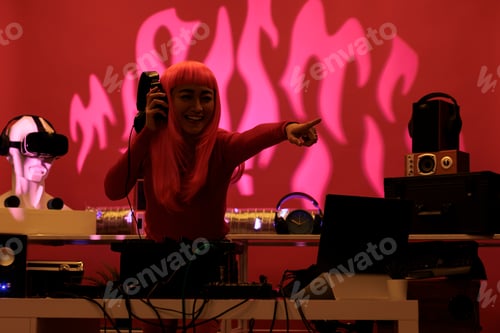 Preview: Asian artist standing at dj table performing techno song using professional turntables enjoying