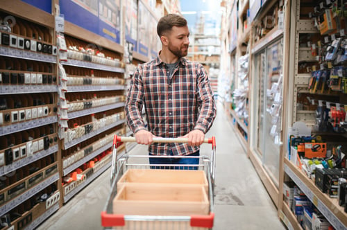 Preview: Portrait of happy mature man standing in hardware store