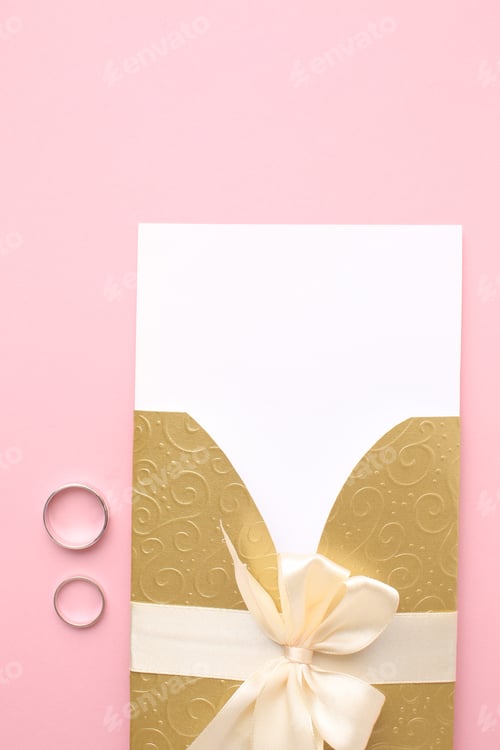 Preview: Wedding card mockup and wedding stationery on stone table. Pastel pink wedding envelopes, gold