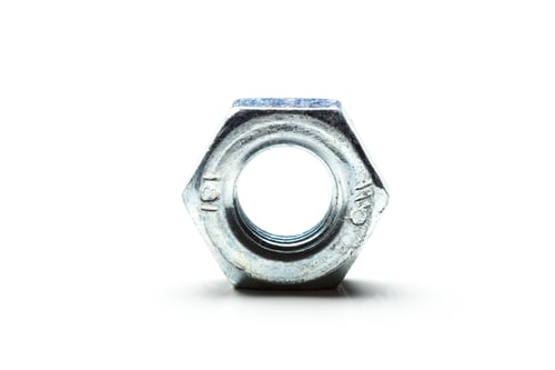 Preview: Metal nut on a white background showcasing details of its design and texture