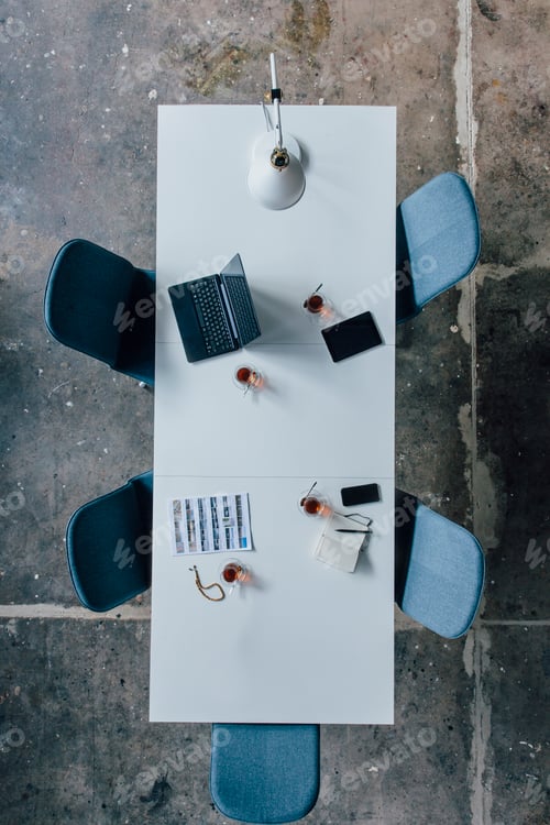 Preview: Conference table seen from above, turkish tea, prayer beads, tablet, smartphone, laptop and notebook