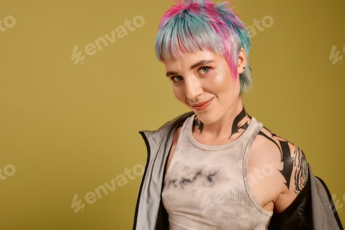 Preview: Young woman showcases vibrant hair and unique style in a creative studio setting