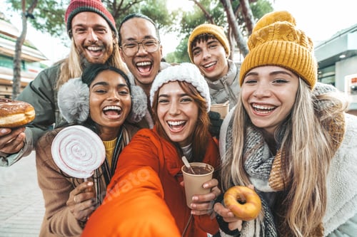 Preview: Happy friends wearing winter clothes taking selfie picture with smart mobile phone outside
