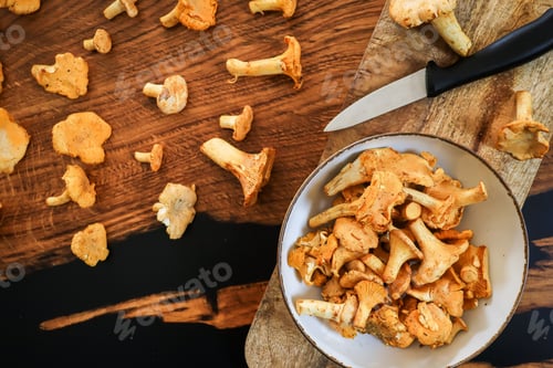 Preview: Chanterelle Mushrooms on Wood Surface with Bowl