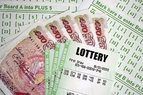 Preview: Green lottery tickets and Great Britain pounds money bills on blank with numbers for playing lottery