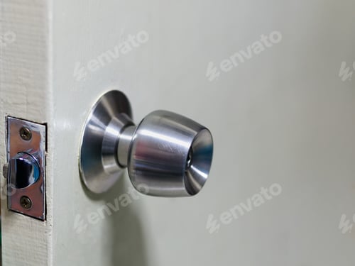 Preview: Close-up Metallic Door Knob on Wooden Door