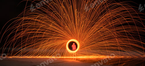 Preview: Closeup shot of a firestarter performing an amazing fire show with sparkles in the nighttime
