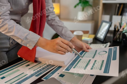 Preview: a muslim female entrepreneur is reviewing her company's financial documents