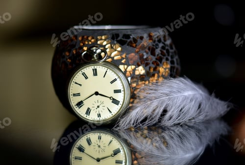 Preview: Old pocket watch on a mirror surface