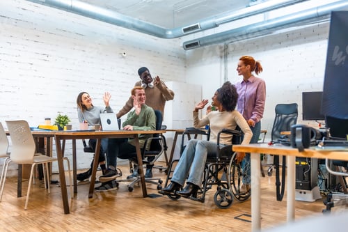 Preview: Coworkers waving to a disabled colleague before leave the room