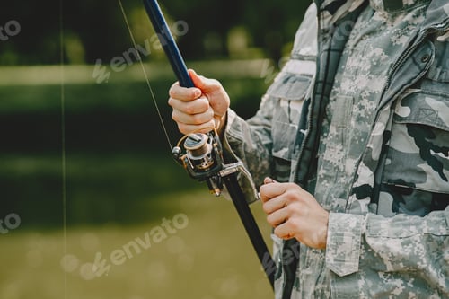 Preview: Man fishing and holds the angling rod