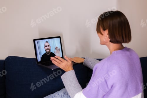 Preview: Woman at home face time video call her friends husband boyfriend, chatting online from laptop