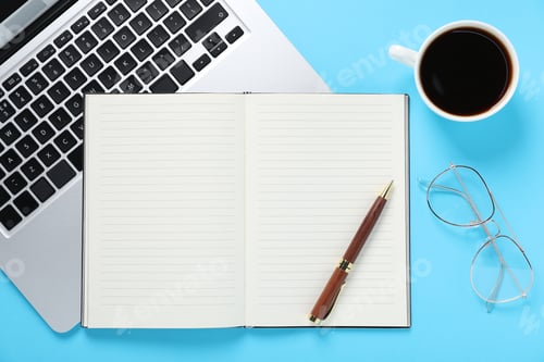 Preview: Pen, open notebook, coffee, glasses and laptop on light blue background, flat lay