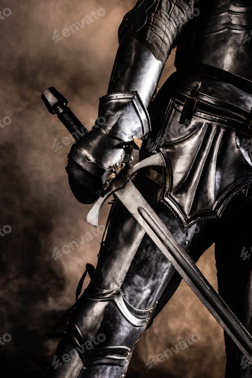 Preview: cropped view of knight in armor holding sword on black background