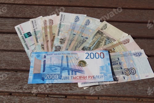 Preview: Closeup shot of Dirham bills on a wooden surface