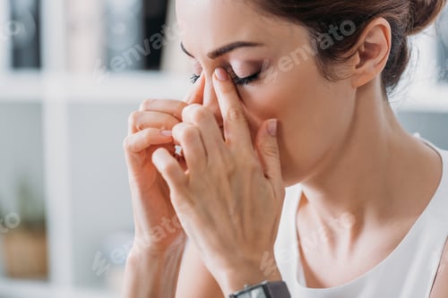 Preview: attractive tired businesswoman having headache