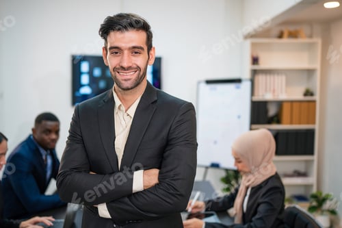 Preview: Successful businessman working and looking camera.