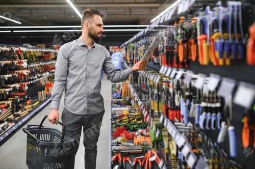 Preview: Portrait of happy mature man standing in hardware store