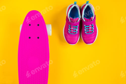 Preview: Skateboard and sneakers on yellow background