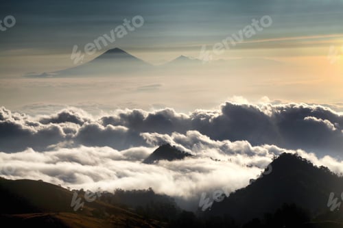 Preview: Horizontal shot of a sea of clouds on Mount Rinjani in Lombok. Mount Agung volcano in the background