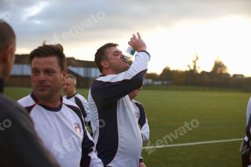 Preview: Football players resting and hydrating at half time