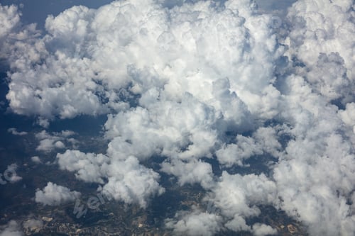 Preview: Cloudy sky background. View out of an airplane window.