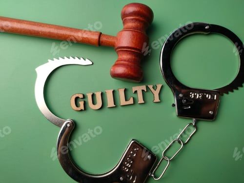 Preview: Top view metal handcuff and wooden gavel with text GUILTY on a green background