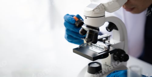 Preview: Quality control in oil refining industry concept. Male chemist hold test tube with yellow liquid bio
