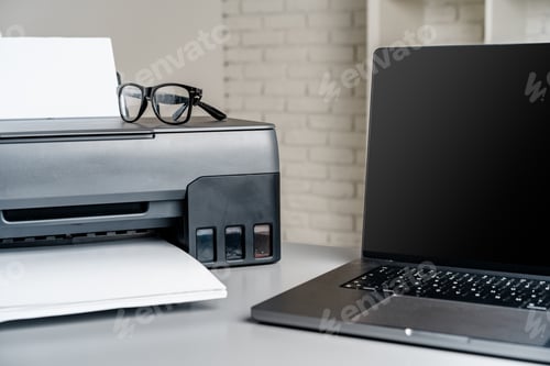 Preview: Printer and laptop on grey table in office